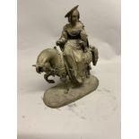 A bronze of a 16th century lady riding a horse and carrying a hawk on a naturalistic bronze