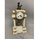 A French marble gilt metal pedestal mantle clock. Enamel face with Arabic markers and floral