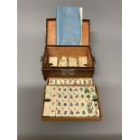 An early 20th century Mah Jong set in fitted leather carry case. Complete with instructions. W: