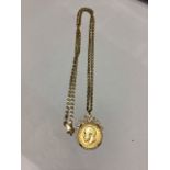 A George V 1914 half sovereign pendant in a 9ct gold bezel and wire work mount on a 9ct flat link