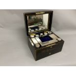 A Victorian coromandel dressing table box with sterling silver mounted glass contents (complete) and