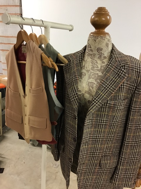 A wool jacket 42 chest together with three vintage waistcoats.