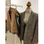 A wool jacket 42 chest together with three vintage waistcoats.