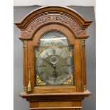 A Fine carved oak three train musical longcase clock,on a plaque to the centre above six o'clock,