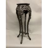 An Oriental carved hardwood marble topped jardiniere stand. W:37cm x D:37cm x H:90cm