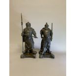 A pair of Japanese style bronze figures of warriors on cast bronze bases with stylised lion head