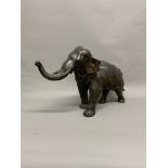 A Japanese Bronze Model of an Elephant, the large pachyderm striding forward with trunk raised.