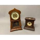 Two 20th century mantle clocks one in The Art Nouvea style with a carved oak example.