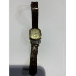 A gentleman's unmarked yellow metal drivers watch by Gruen. Rectangular cream face with Arabic