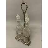 A silver plated three bottle table top decanter set. H:46cm