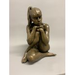 A large bronze figure of a nude seated girl with head resting on knee. Indistinctly signed with