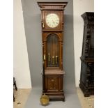 A large 20th century oak longcase clock, the case with arched glazed door. Triple weight chiming