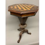An antique mahogany trumpet shaped games table with hinged top to sectioned inner.W:45cm x D: