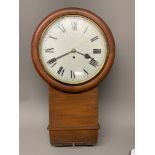 A late 19th to early 20th Century mahogany drop head wall clock, with white painted wooden dial.