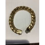 An Italian 9ct gold heavy flat curb link bracelet with import stamp. 22cm. 87g.