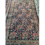 A Persian style rug red ground with floral decoration. W:155cm x D:cm x H:275cm