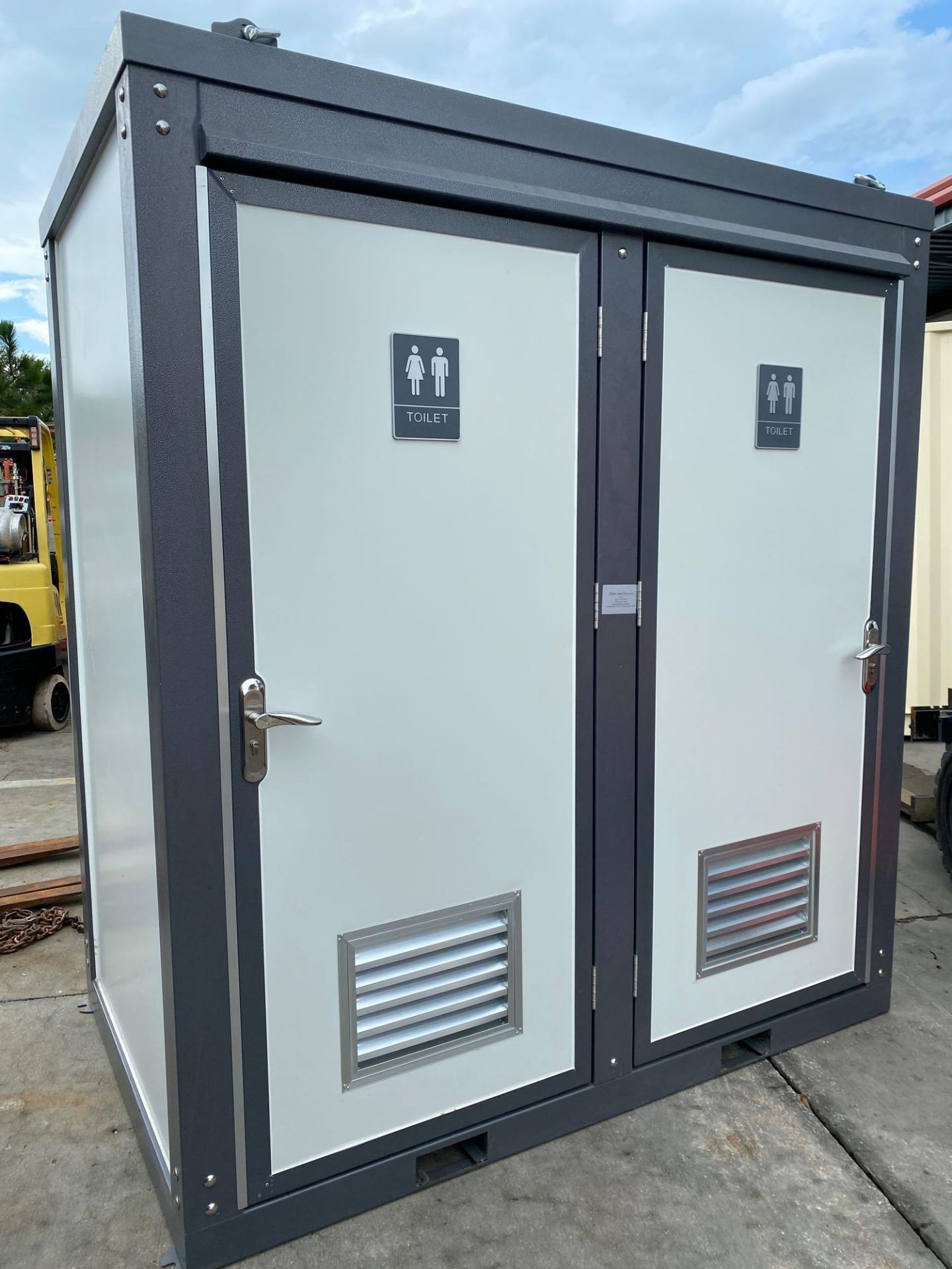 UNUSED PORTABLE 2 STALL BATHROOM UNIT. PLUMBING AND ELECTRIC HOOKUP, FORK POCKETS