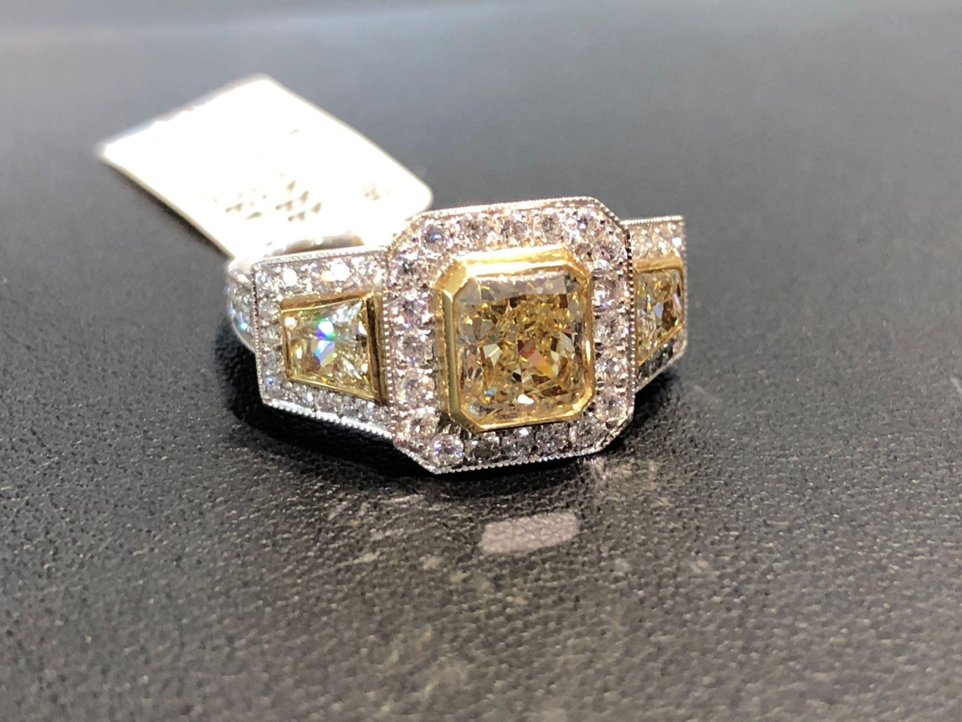 CUSTOM 1.48CT RADIANT YELLOW CENTER DIAMOND, .88CT TOTA FANCY YELLOW TRAPEZOID SIDE DIAMONDS, .77CT