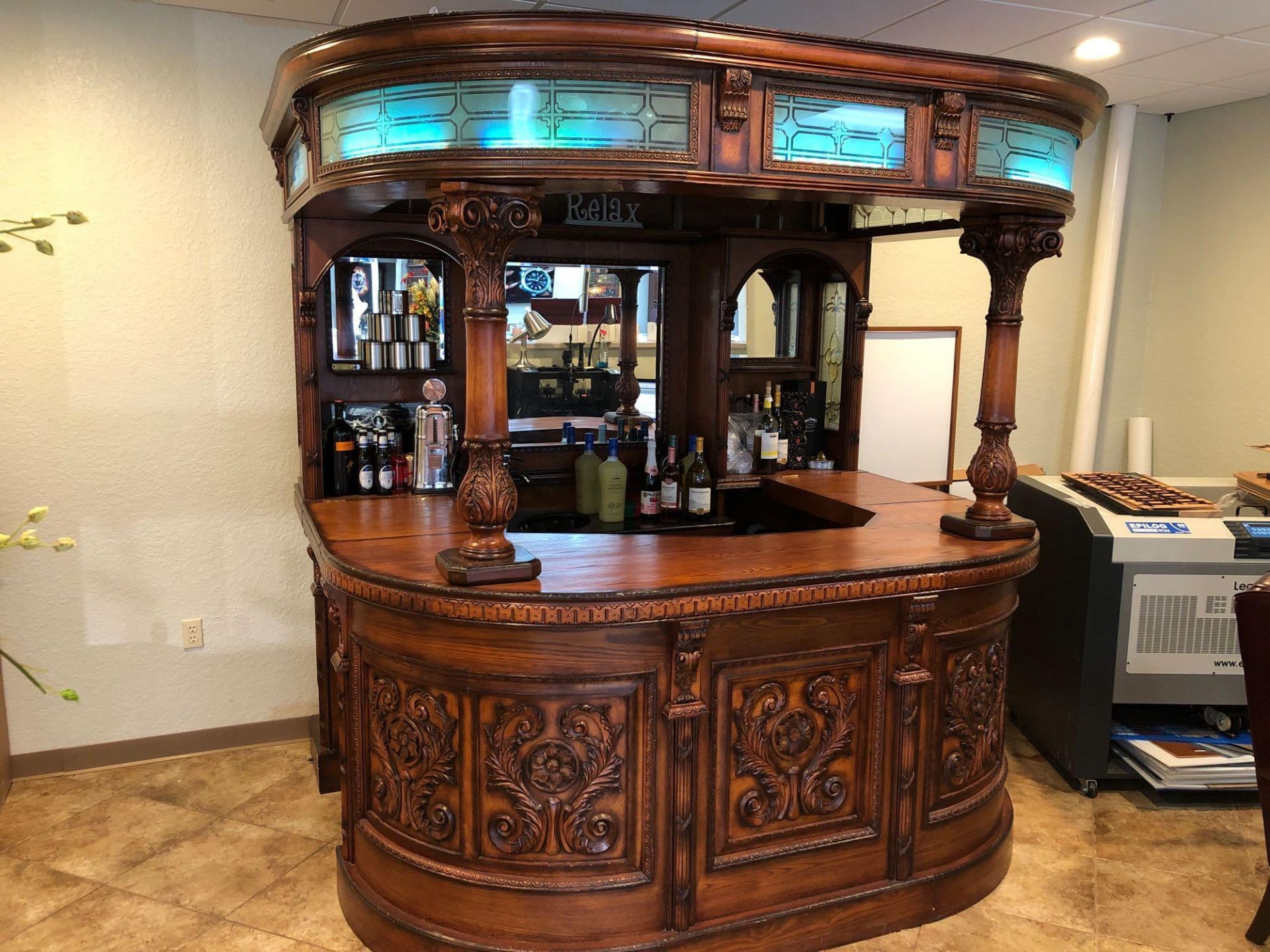 CUSTOM CARVED WOOD BAR WITH SINK. CURVED GLASS; LED LIGHTS. APPROX 72"'DEEP X 90"'WIDE X 92"TALL (DO