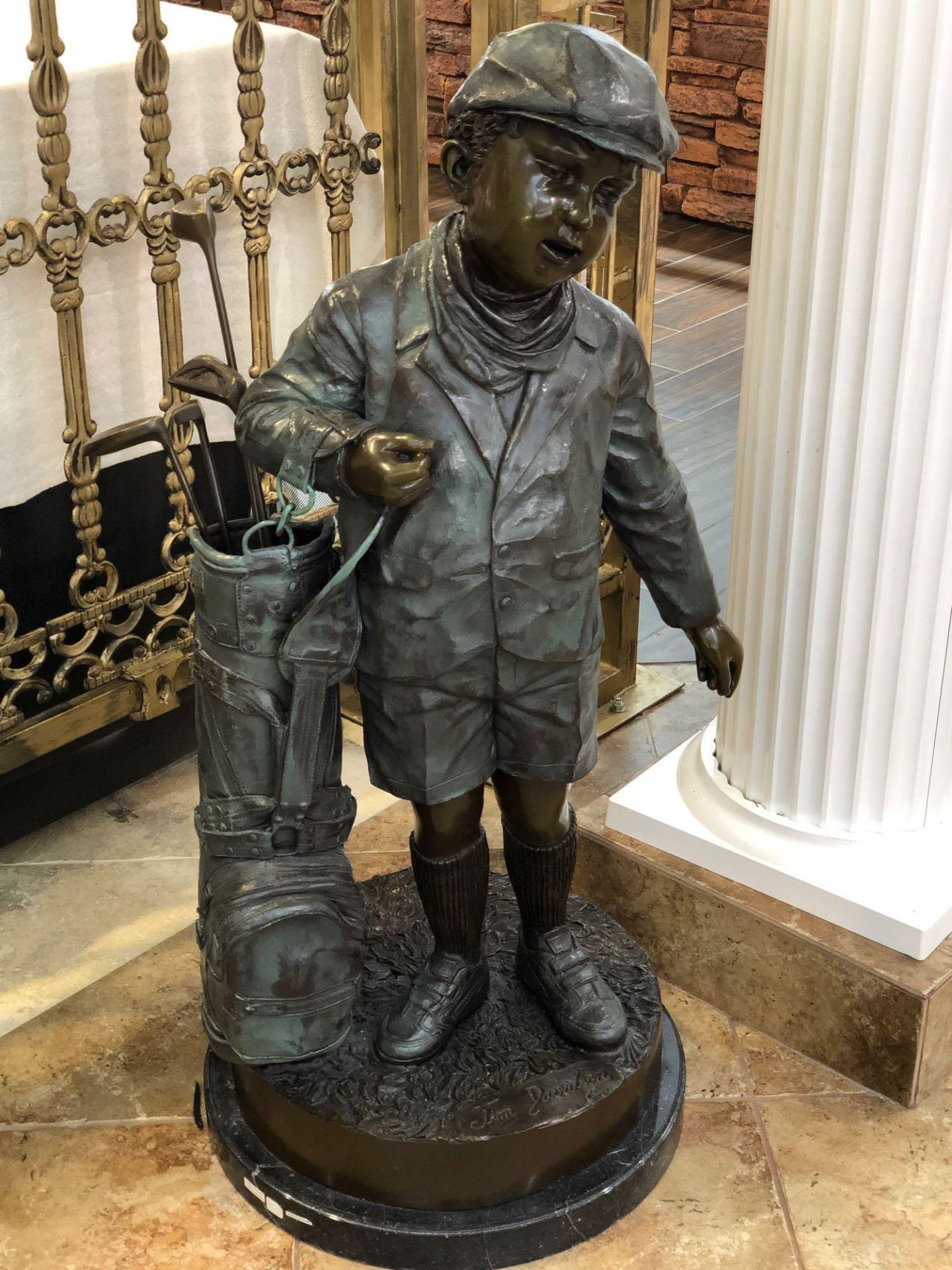 BOY GOLFER WITH BAG AND CLUBS BRONZE. APPROX 42" TALL X 19" BASE DIAMETER