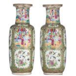 Two Chinese Canton rouleau vases, the roundels decorated with birds, butterflies and animated scenes