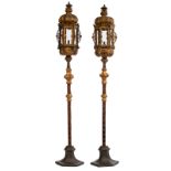 An imposing pair of Italian Baroque gilt bronze lanterns, decorated with angel heads, on two matchin
