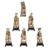 A series of six Chinese ivory Immortals (out of a total of eight), five of them on a hard wooden bas