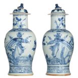 A pair of Chinese blue and white vases and covers, decorated with birds, fish and flower branches, 1