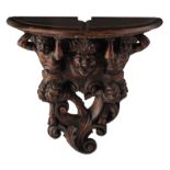 A Baroque style patinated pine console table, decorated with sculpted Bacchus figures, H 70 cm