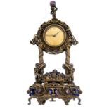 A silver-plated Reuge music clock, richly decorated with semi-precious stone inlay, playing 'Eine kl