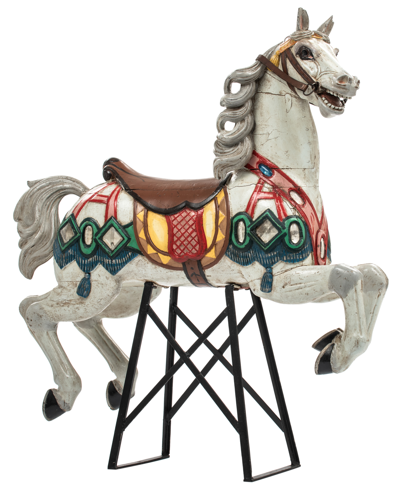 A polychrome painted carousel horse, with glass and silver foil inlay, mounted on a later period wro