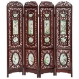 A Chinese rosewood four-panel screen, decorated with richly sculpted openwork ornaments and inlaid f