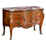 A French Louis XV style cherry, rosewood and walnut veneered commode, exuberantly decorated with gil