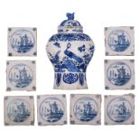 A blue and white decorated Delftware octagonal baluster vase and cover, decorated with a chinoiserie