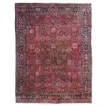 A large Oriental woollen rug, decorated with geometric motifs, 443,5 x 340,5 cm