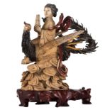 A Chinese polychrome and gilt ivory carved group, depicting a lady seated on a phoenix on clouds, on