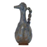 An exceptional relief decorated salt-glazed stoneware pitcher of Bouffiloux, with a braid-shaped han
