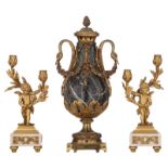 A fine pair of Neoclassical Carrara marble and ormolu bronze candlesticks, shaped like cupids holdin
