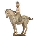 A cold painted Tang-type earthenware Ferghana horse with on top a foreigner, H 42 cm