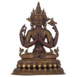 A Tibetan bronze statue of a seated four-armed Buddhist figure, on a double lotus flower base, 18th/