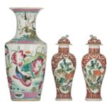 A pair of Chinese iron red baluster-shaped vases and covers, the roundels decorated with fish, with