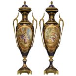 A pair of covered Sèvres type vases, bleu royale ground and the roundels polychrome decorated with a