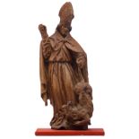 An oak sculpture of Saint Romanus of Rouen, with traces of polychrome paint, 16th/17thC, the Souther