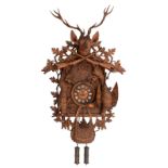 A so-called 'Jagdstück' cuckoo clock, decorated with sculpted hunting attributes and trophies, the B