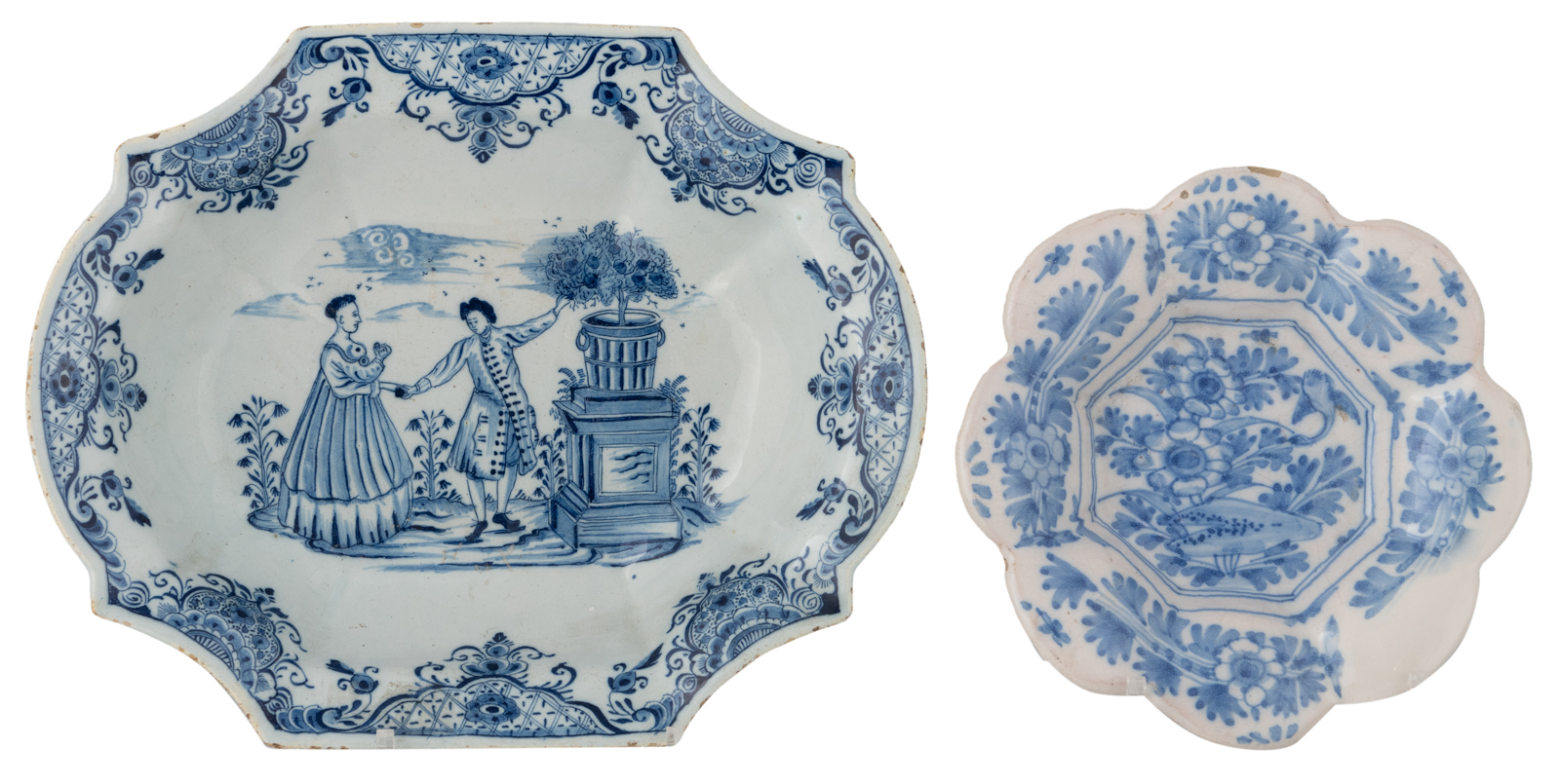 A blue and white decorated Dutch Delftware charger, depicting a gallant scene of a man picking an ap