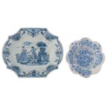 A blue and white decorated Dutch Delftware charger, depicting a gallant scene of a man picking an ap