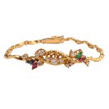 An 18ct gold bracelet set with brilliant-cut diamonds and marquise cut rubies and emeralds, with a s