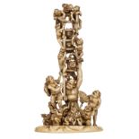 A Japanese patinated ivory okimono, depicting a jolly Oni party, signed, late Edo – early Meiji peri