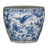 A Chinese blue and white jardiniere, all-over decorated with flowers and birds in a river landscape,