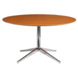 A round dining table, with a chromed base and a pearwood tabletop, design by Florence Knoll for Knol